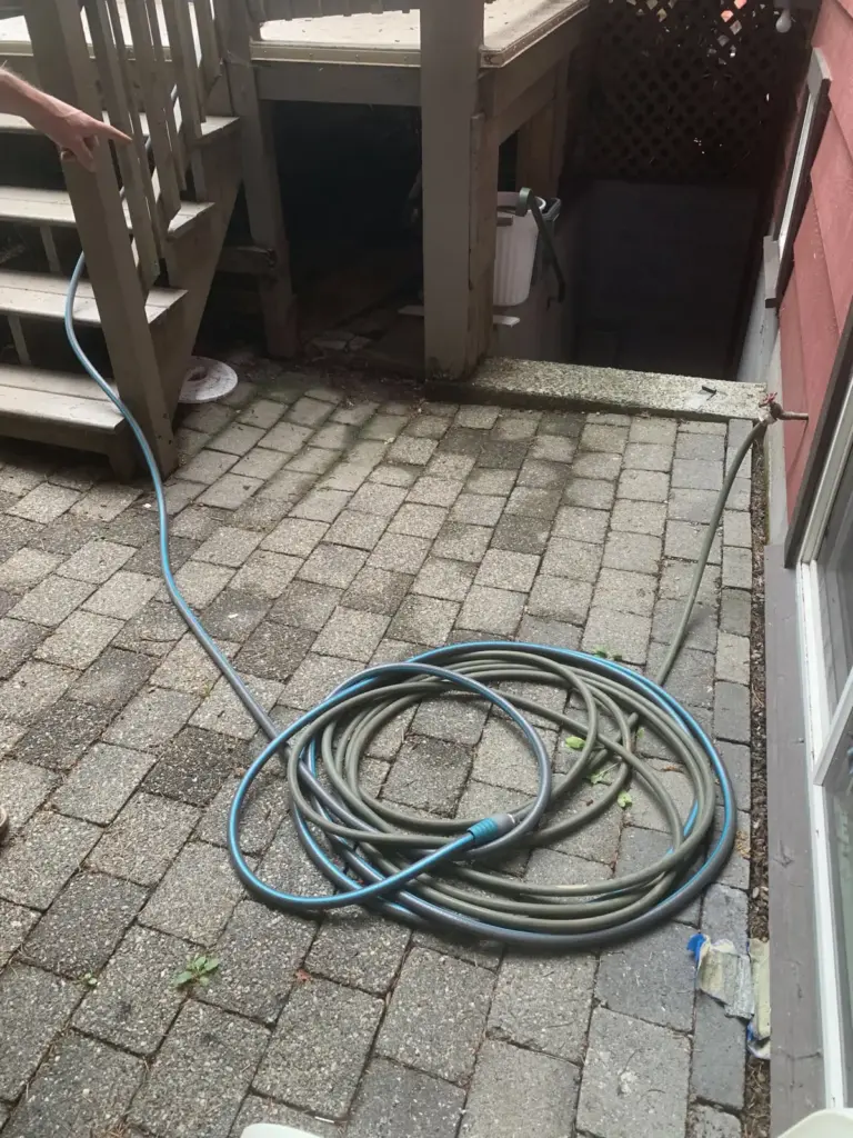 Old uneven pavers at the foot of the deck stairs