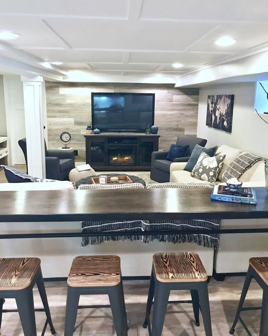 Finished basement family room with coffered ceiling and bar counter