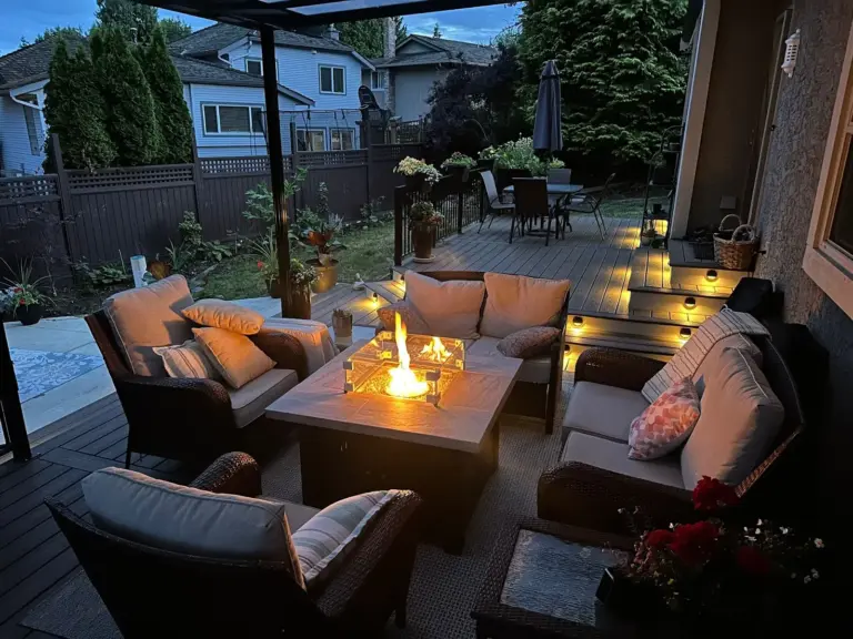Backyard deck lounge around a fire table with step lighting