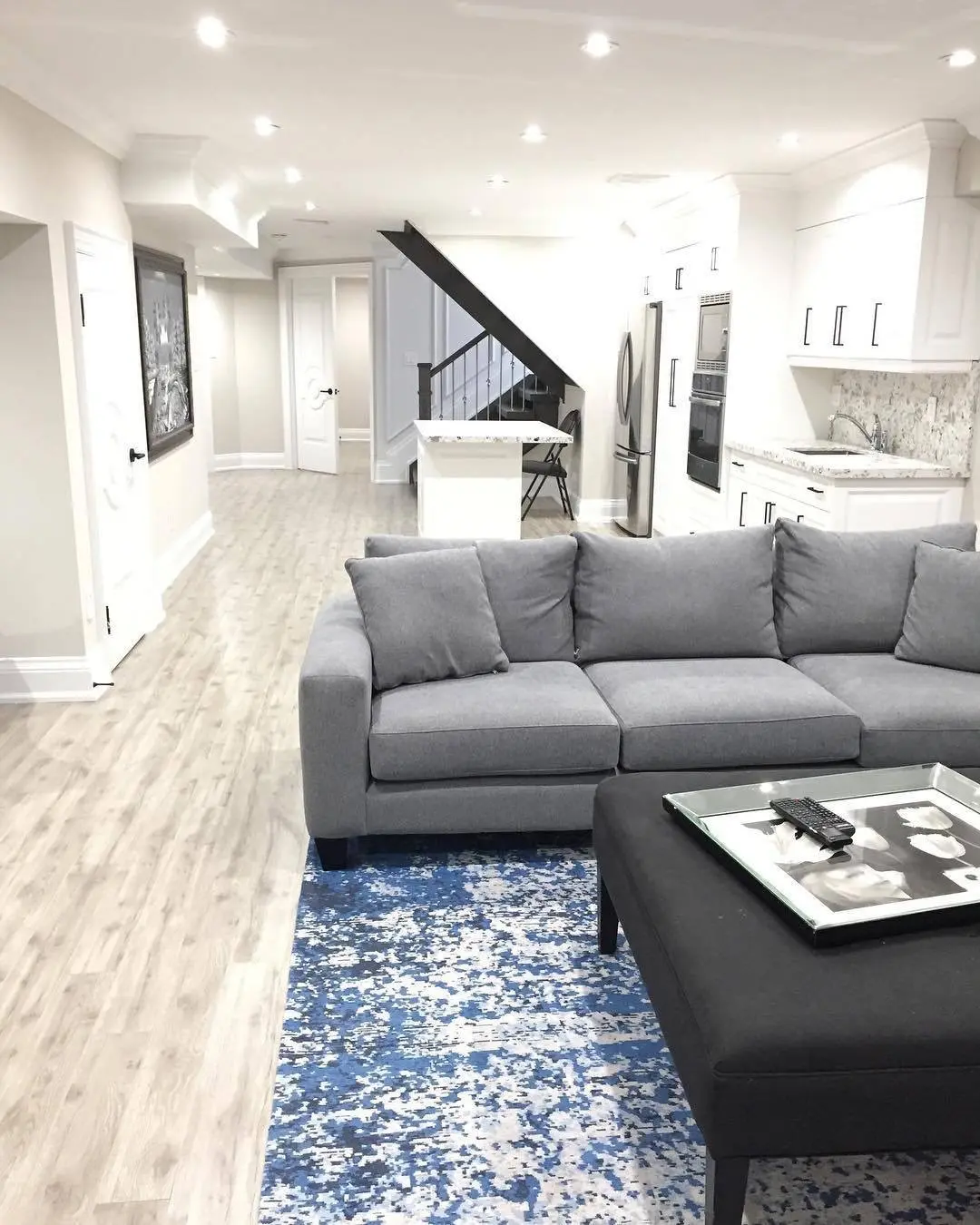 Finished basement suite with open living area and kitchen