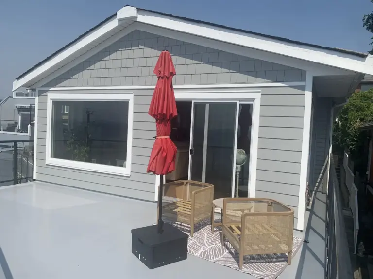 New picture window and patio door on the resurfaced deck, exterior renovation in White Rock