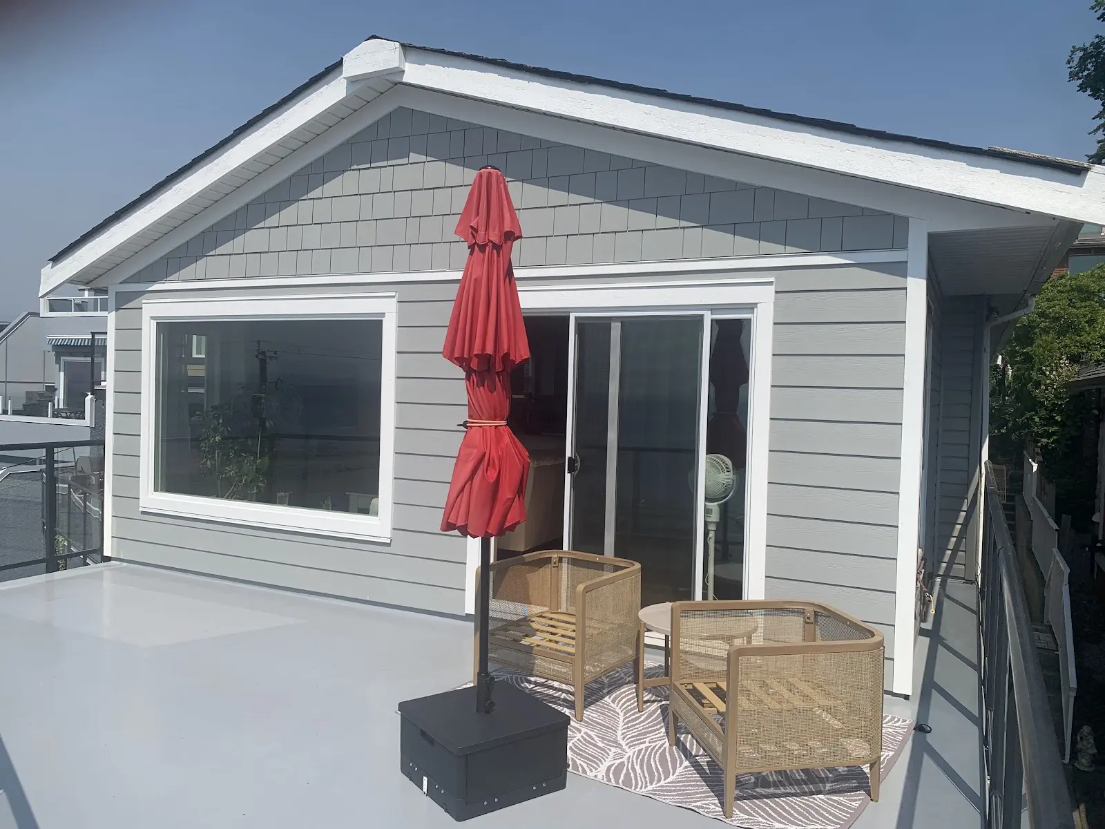 Deck with new grey siding, picture window and patio door, exterior renovation in White Rock