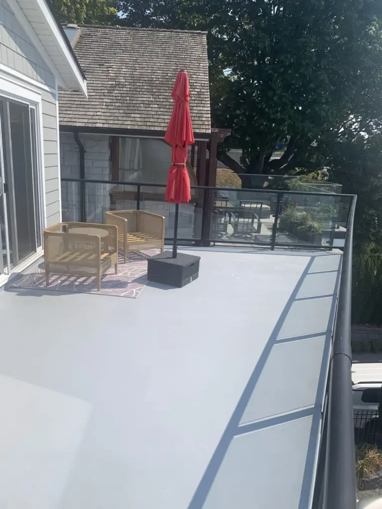 Resurfaced upper patio beside new siding, deck resurfacing in White Rock