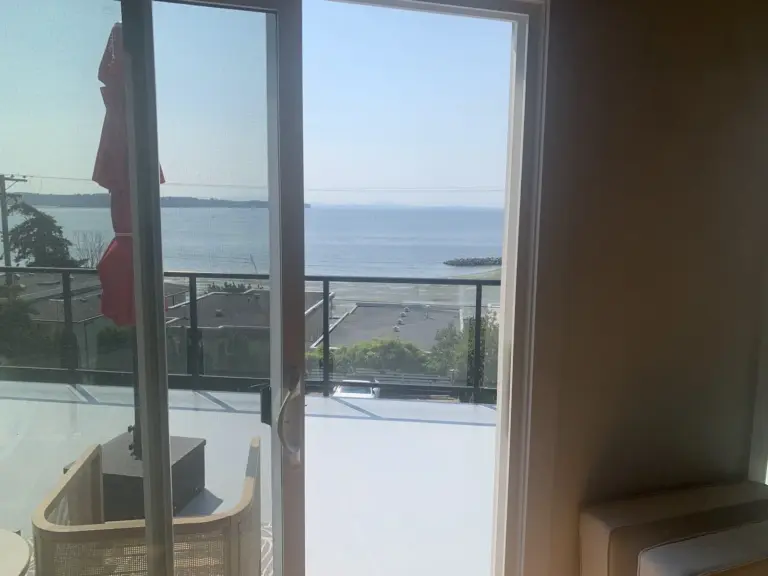 View through the new patio door to the deck and the bay, door replacement in White Rock