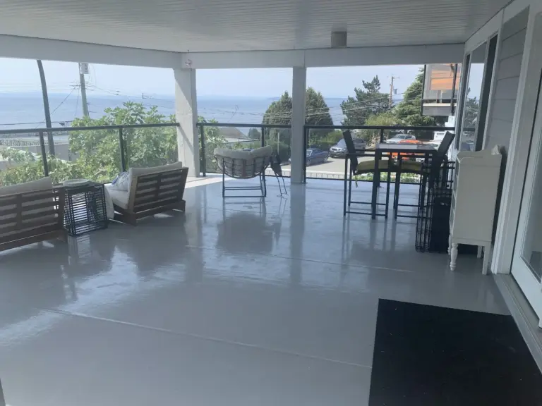 Covered patio with resurfaced floor and water view, deck resurfacing in White Rock