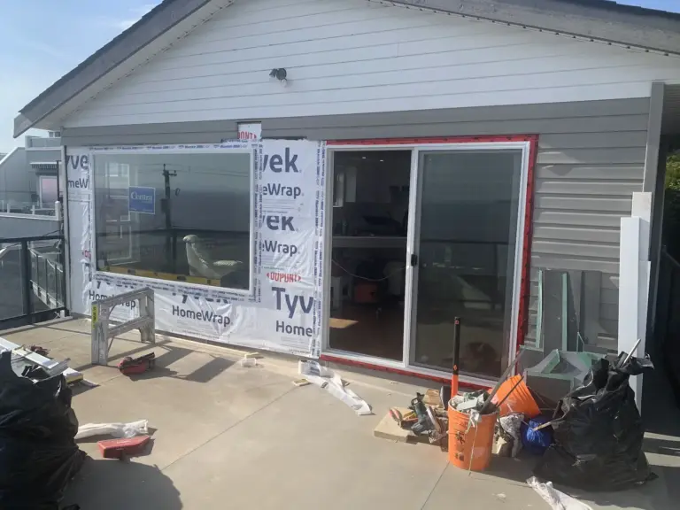 Walls wrapped in weather barrier with the new window and door installed, siding replacement in White Rock